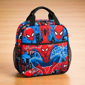 A colorful lunch bag featuring the Spider-Man character, with various Spider-Man logos and designs.