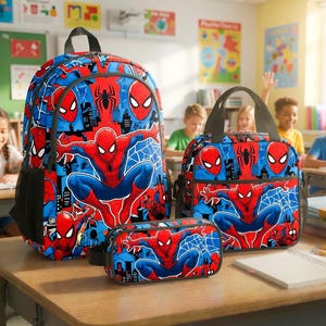 A collection of Spiderman-themed school supplies, including backpacks, lunch bags, and pencil cases, are displayed in a classroom setting.