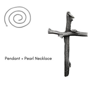 May include: A silver-colored necklace with a spiral design and a rustic cross pendant. The cross pendant has a textured, wood-like appearance. The text "Pendant + Pearl Necklace" is displayed below the necklace.