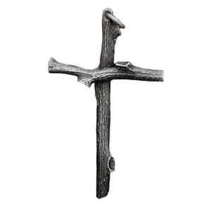 May include: A rustic-style cross made from a dark gray, textured material, resembling wood. The cross has a ring at the top for hanging. The design features a natural, organic aesthetic, with the arms and vertical beam of the cross crafted to mimic the look of tree branches.