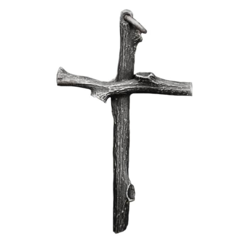 May include: A rustic-style cross made from a dark gray, textured material, resembling wood. The cross has a ring at the top for hanging. The design features a natural, organic aesthetic, with the arms and vertical beam of the cross crafted to mimic the look of tree branches.