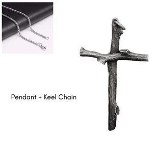 May include: A silver-colored chain necklace with a cross pendant. The cross pendant has a rustic, textured appearance, resembling a wooden branch. The text "Pendant + Keel Chain" is displayed below the chain.