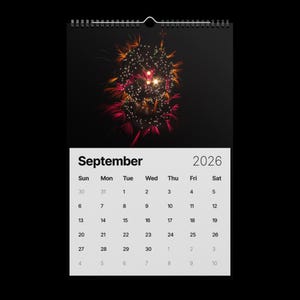 May include: A wall calendar for September 2026, featuring a vibrant fireworks display against a black background. The calendar grid is white with black text. The fireworks are a mix of red, orange, and yellow.