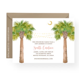 May include: A white card with a watercolor illustration of two palm trees with a crescent moon and string lights. The text on the card reads "The Steinberg family has a new address in sunny South Carolina. James, Laura and Emilie, 123 Palmetto Drive, Mount Pleasant, SC 29464, Steinburgs@email.com".