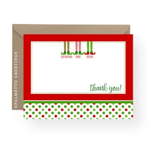 May include: Red and green Christmas thank you card with a white interior. The card features a row of three elf legs with green and red striped stockings and green elf shoes. The names "Catherine", "Mae", and "Abbie" are written below the elf legs. The card has a red border and a green and red polka dot pattern at the bottom. The text "thank you!" is written in green on the card.