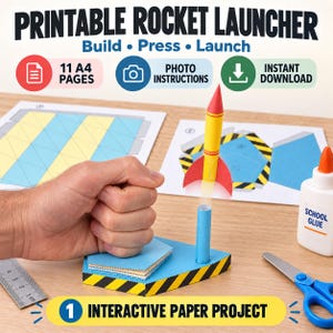 May include: A printable paper rocket launcher project featuring a yellow and red paper rocket, a blue launch base with yellow and black hazard stripes, a bottle of school glue, scissors, and a metal ruler. Text includes PRINTABLE ROCKET LAUNCHER.