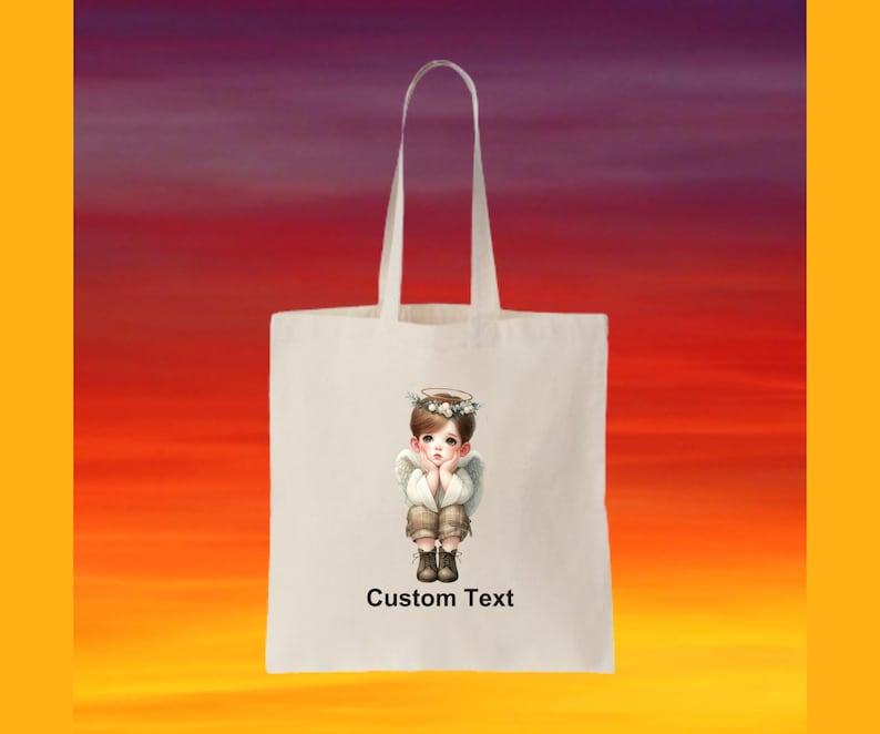 May include: White tote bag with a design of a young angel with a halo and wings. The text "Custom Text" is printed on the bag.