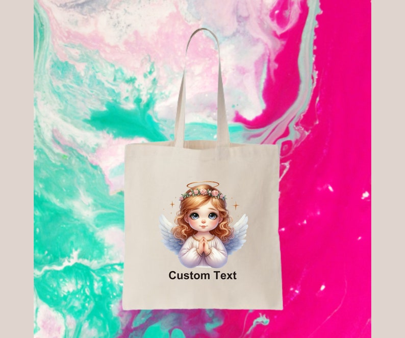 May include: A white tote bag with a cartoon angel with blonde hair and a halo. The angel is wearing a white dress and has her hands clasped in prayer. The bag has the text "Custom Text" printed on it.