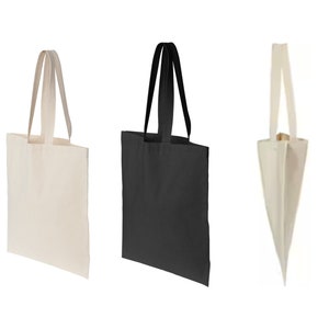 May include: Three tote bags, one white, one black, and one natural canvas. The bags have a simple design with two handles.