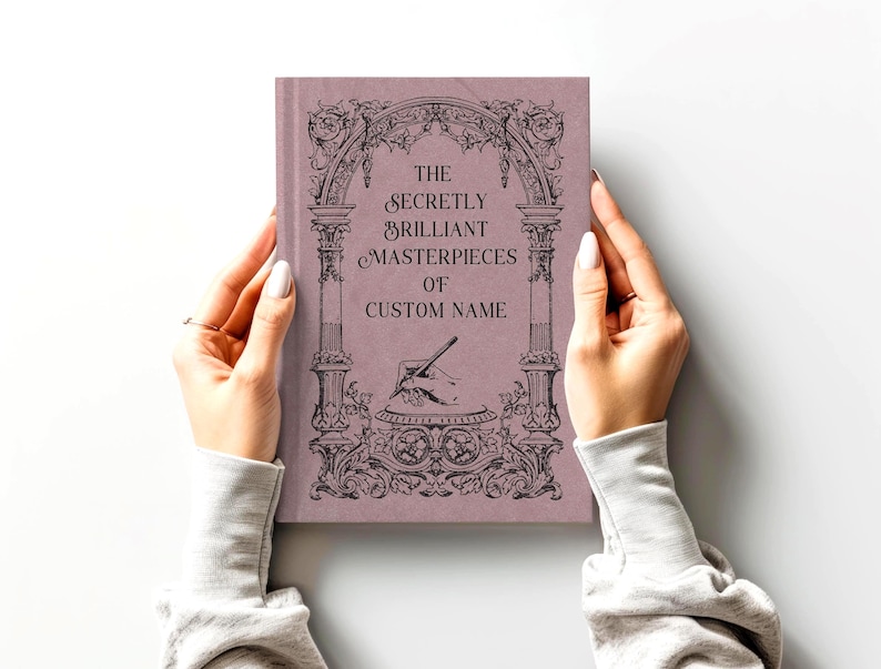 Journal shown in the color "raisin" by a model's hands on a smooth light gray surface.