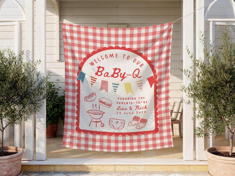 Vertical banner hung by a white cord on a porch between 2 white pillars with a tree on either side. It is a sunny day with subtle shadows scattered across the fabric tapestry.