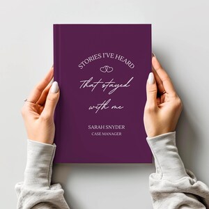A5 hardcover lined journal shown by a model in the color "mulberry."