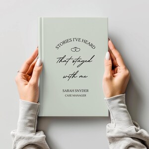 A5 hardcover lined journal shown by a model in the color "sage."