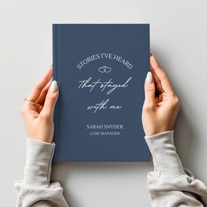 A5 hardcover lined journal shown by a model in the color "navy."