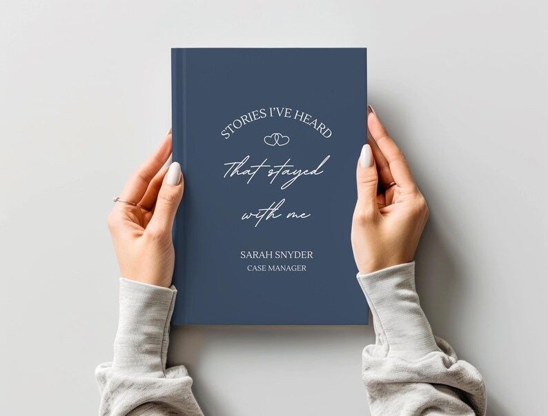 A5 hardcover lined journal shown by a model in the color "navy."