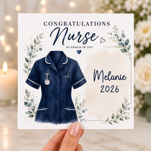 May include: A square greeting card featuring a navy blue nurse uniform with white trim, a fob watch, and a pen. The text reads CONGRATULATIONS Nurse SO PROUD OF YOU, Melanie, and 2026. The design is framed by watercolour greenery and small hearts.