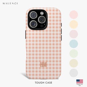 May include: A phone case featuring a peach and white gingham design. The case has a black camera module and black side buttons. The initials "HM" are printed in the centre. The text "TOUGH CASE" is at the bottom. The brand name "MALENCI" is at the top.