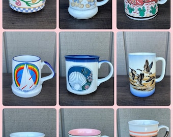 May include: A collection of nine ceramic mugs with various designs. The mugs feature floral patterns, teddy bears, abstract art, a sailboat, a seashell, ducks, a child, and fruit. Each mug has a handle and is in different sizes and shapes.