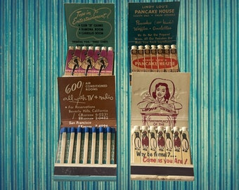 May include: Two vintage matchbook covers. The left cover advertises a hotel with 600 air-conditioned rooms, all with TV and radio. The right cover advertises a pancake house with the text "Lindy Lou's Pancake House" and "Showplace of the Why be formal? Come as you are!"