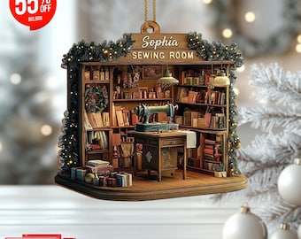 May include: A wooden Christmas ornament shaped like a miniature sewing room. The ornament features a sewing machine, shelves filled with books and sewing supplies, and the text "Sophia SEWING ROOM". The ornament is decorated with lights and greenery.