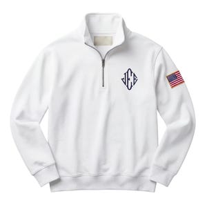 May include: White quarter-zip sweatshirt with a navy blue monogram and an American flag patch on the sleeve. The sweatshirt has a stand-up collar and a silver zipper. The monogram is in a diamond shape.