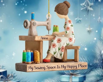 May include: A decorative Christmas ornament featuring a woman sewing on a vintage sewing machine. The woman is wearing a floral dress and red shoes. The ornament includes spools of thread in various colors and the text "My Sewing Space Is My Happy Place."