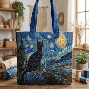 May include: Quilted tote bag with a black cat against a starry night sky, in the style of Van Gogh. It has blue quilted handles and a detailed, textured design. The colour scheme includes blues, yellows, and blacks. The bag is ideal for carrying items.