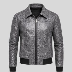 May include: A grey and black snakeskin patterned jacket with a full-length silver front zipper, a classic collar, and black ribbed knit cuffs and hem. The jacket features long sleeves and two vertical side pockets, showcasing a textured finish.