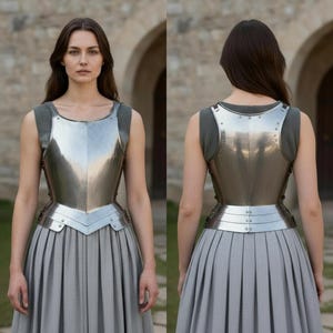 May include: A polished steel breastplate featuring a central vertical ridge and a multi-layered fauld at the waist. The armor is worn over a grey sleeveless garment with visible chainmail at the shoulders, showing both front and back views.