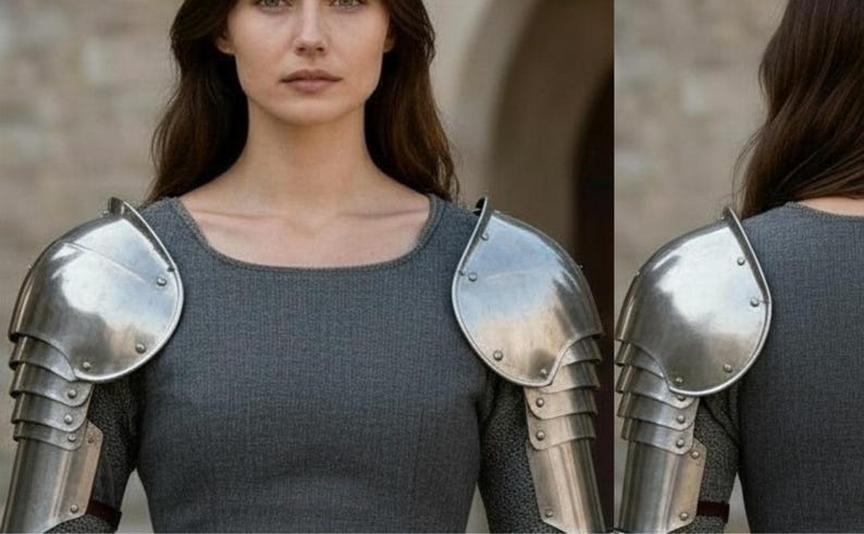 May include: A set of polished steel pauldrons featuring a multi-layered articulated design with visible rivets. The shoulder armor is worn over a grey long-sleeved garment, showcasing a metallic finish and a structured, protective construction.