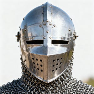 May include: A polished, silver-colored medieval helmet with a riveted construction. The helmet features a visor with eye slits and a series of ventilation holes. A chainmail coif is visible at the base. The helmet has a pointed top and is designed for protection.