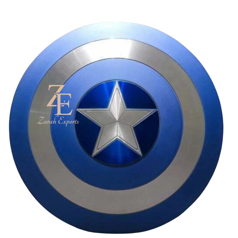 May include: A blue and silver shield with a central silver star design. The shield has concentric circles of blue and silver, with the text "Zarah Exports" visible. A classic superhero accessory.
