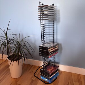Vintage black metal DVD and video game rack, 38-disc multimedia support, industrial style storage