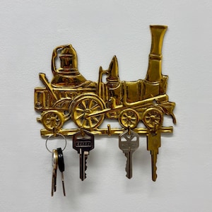 May include: A set of three ceramic mugs with a speckled, matte finish in cream, light grey, and dark grey. Each mug has a simple, minimalist design, suitable for coffee or tea.