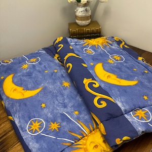 May include: A white ceramic mug with a black handle and the text "But First, Coffee" in a black, handwritten-style font. The mug is on a white surface.