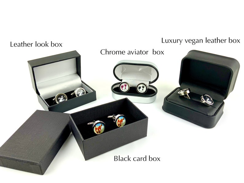 May include: An assortment of cufflinks in various cases. The cases include a leather look box, a chrome aviator box, a luxury vegan leather box, and a black card box. The cufflinks feature different designs, including a horse, a footprint, and a black and white image.