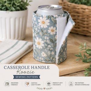 May include: A fabric beverage insulator wrap featuring a light blue background with a white daisy floral pattern. The wrap has a vertical white hook-and-loop fastener strip along the side and is shown wrapped around a silver metal beverage can.