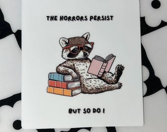 The Horrors Persist But So Do I Vinyl Sticker | Funny Book Raccoon Vinyl Decal