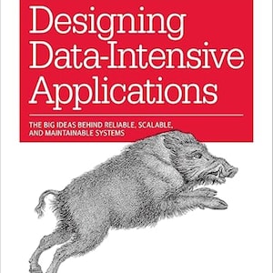 May include: A book titled Designing Data-Intensive Applications by Martin Kleppmann, published by O'Reilly. The cover features a red rectangular block with white text and a detailed black and white line drawing of a wild boar leaping forward.