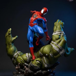 May include: A detailed statue of Spider-Man standing on top of a defeated Hulk. Spider-Man is in a classic red and blue suit. Hulk is green with white bandages. The base is dark with the text "KyleVerseStudio".