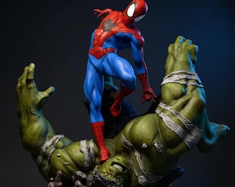 May include: A detailed statue of Spider-Man standing on top of a defeated Hulk. Spider-Man is in a classic red and blue suit. Hulk is green with white bandages. The base is dark with the text "KyleVerseStudio".