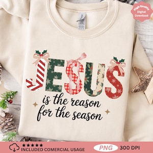 May include: A cream-coloured sweatshirt featuring the phrase "JESUS is the reason for the season." The word JESUS is adorned with festive patterns and bows. The design includes stars and holiday elements, ideal for Christmas.
