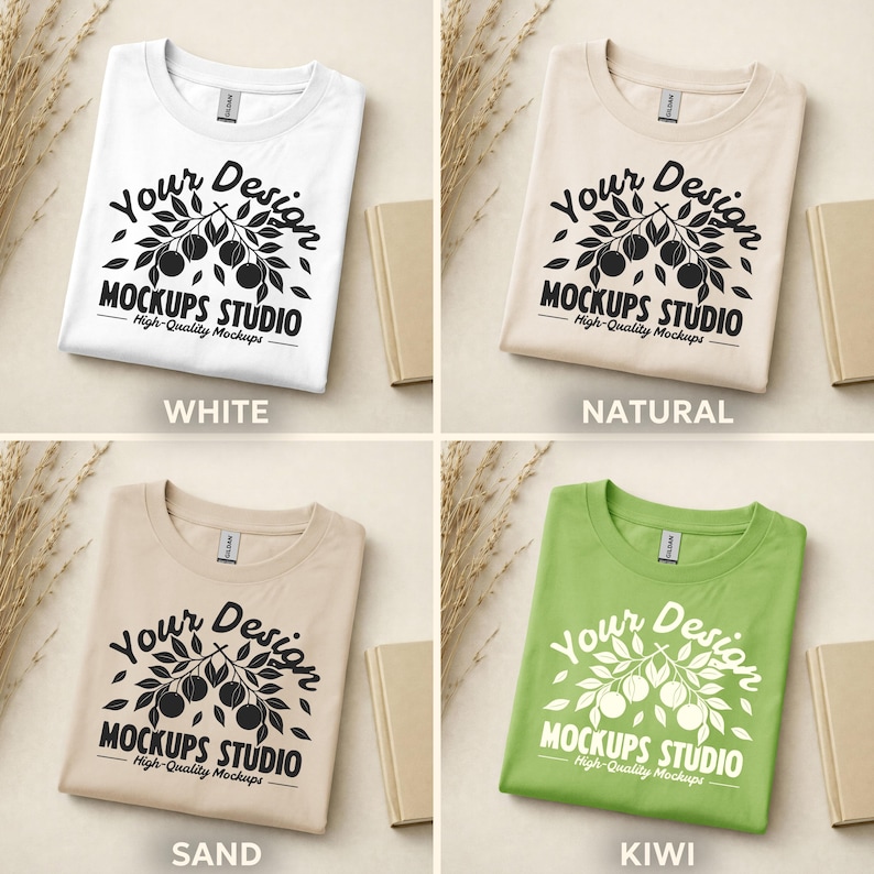 May include: Four folded t-shirts in white, natural, sand, and kiwi green. Each shirt features a graphic with the text "Your Design MOCKUPS STUDIO High-Quality Mockups". The shirts are displayed with small beige books and dried plants.