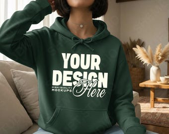 May include: A dark green hoodie with a front pocket and a drawstring hood. The hoodie features the text "YOUR DESIGN Here" in white, with "HIGH-QUALITY MOCKUPS" below. The sweatshirt is made of a soft material.