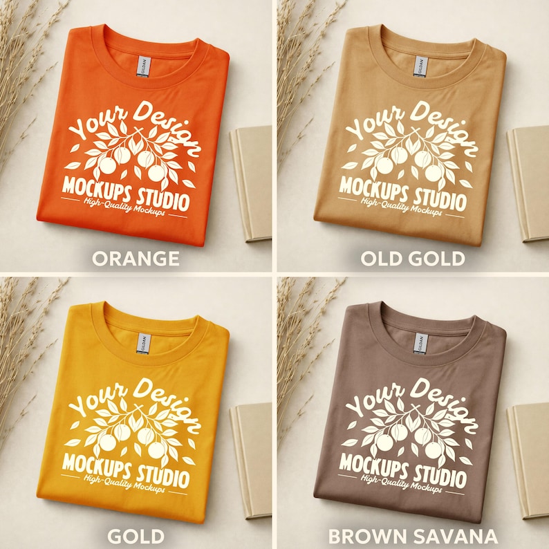 May include: Four folded t-shirts in orange, old gold, gold, and brown savanna colors. Each shirt has a white graphic with the text "Your Design MOCKUPS STUDIO High-Quality Mockups". The word "ORANGE", "OLD GOLD", "GOLD", and "BROWN SAVANA" are printed below each shirt.