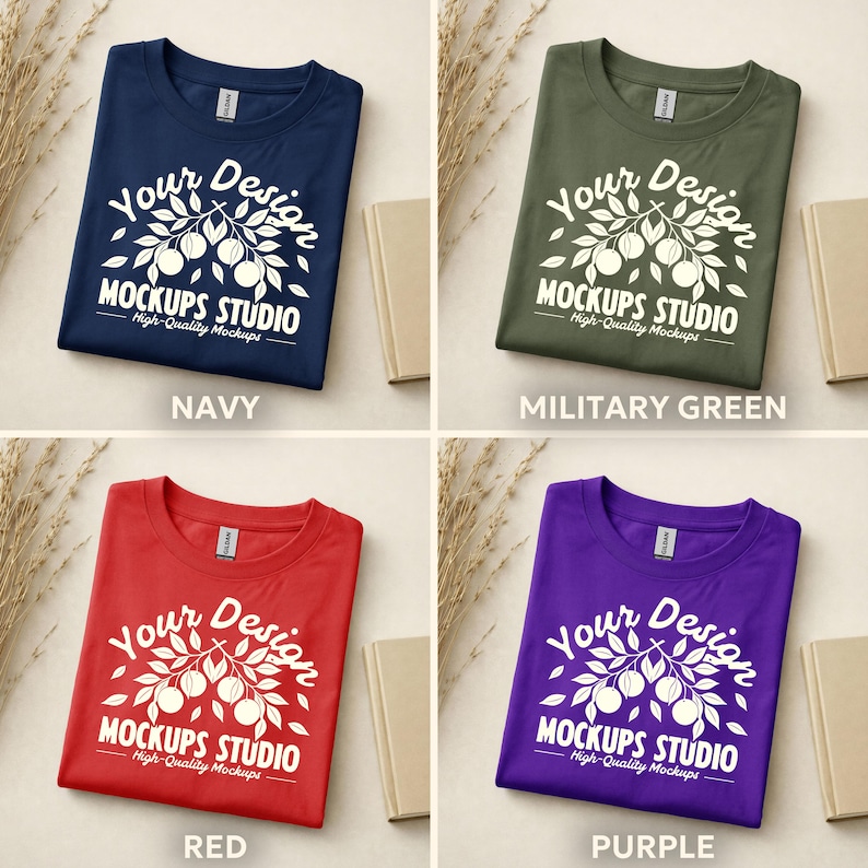 May include: Four t-shirts in navy, military green, red, and purple. Each shirt features a white graphic with the text "Your Design MOCKUPS STUDIO High-Quality Mockups". The shirts are displayed on a neutral background with a book and dried plants.