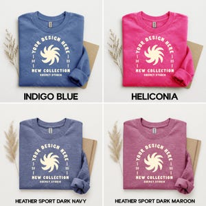 Puede incluir: Cuatro sudaderas de cuello redondo en azul &iacute;ndigo, heliconia, azul marino oscuro deportivo jaspeado y granate oscuro deportivo jaspeado. Cada sudadera presenta un gr&aacute;fico blanco con el texto "YOUR DESIGN HERE", "NEW COLLECTION" y "SHEMET.STUDIO".