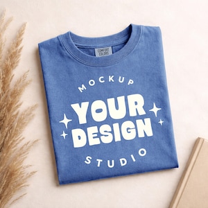 May include: A white ceramic mug with a black handle and the text "But First, Coffee" in a bold, black font. The mug is set against a blurred background, suggesting a cozy setting.