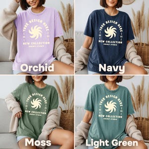 May include: Four t-shirts in orchid, navy, moss, and light green. Each shirt has a crew neck and a graphic design with the text "YOUR DESIGN HERE" and "NEW COLLECTION SHEMET STUDIO". The shirts are displayed on a person.