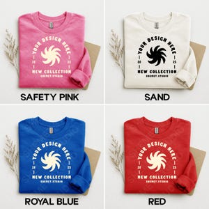 Puede incluir: Cuatro sudaderas de cuello redondo en rosa, crema, azul real y rojo. Cada una presenta un dise&ntilde;o circular con el texto "YOUR DESIGN HERE", "NEW COLLECTION" y "SHEMET.STUDIO."